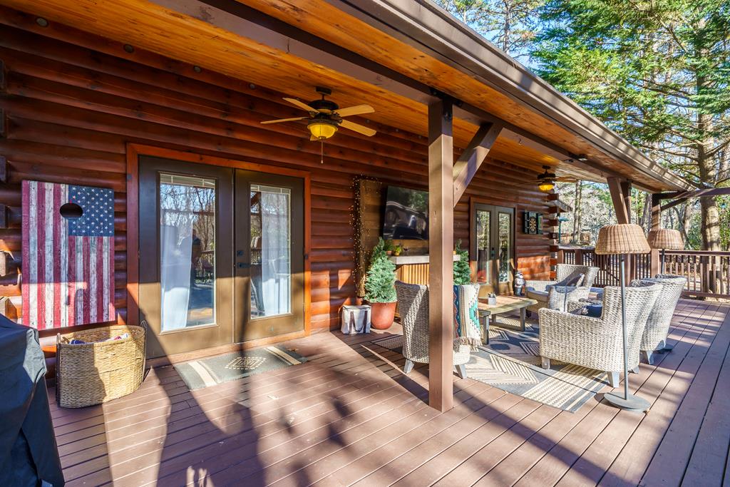 229 Ringtail Run Murphy, NC 28906 - Photo 39 of 68 a view of a patio with a dining table and chairs with wooden floor and fence
