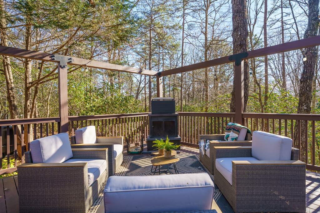 229 Ringtail Run Murphy, NC 28906 - Photo 51 of 68 a view of a patio with couches chairs and wooden floor