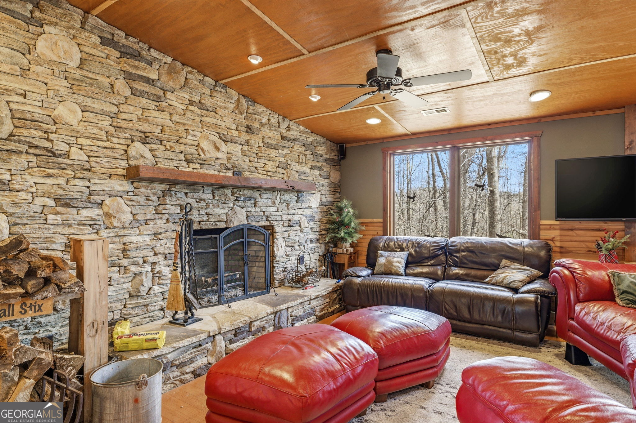 401 Herrin Road Cornelia, GA 30531 - Photo 59 of 83 a living room with furniture a flat screen tv and a fireplace