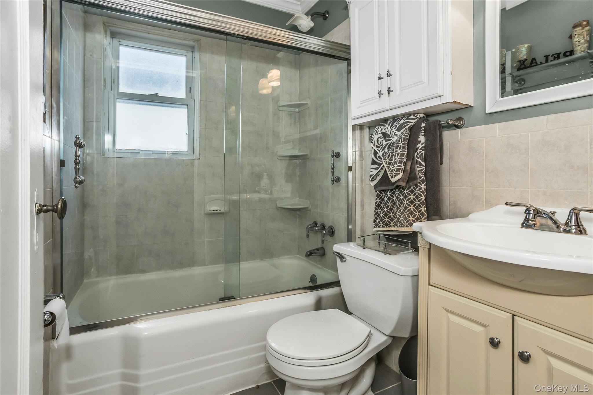 232 Ribbon Street Franklin Square, NY 11010 - Photo 11 of 19 a bathroom with a sink a toilet and shower