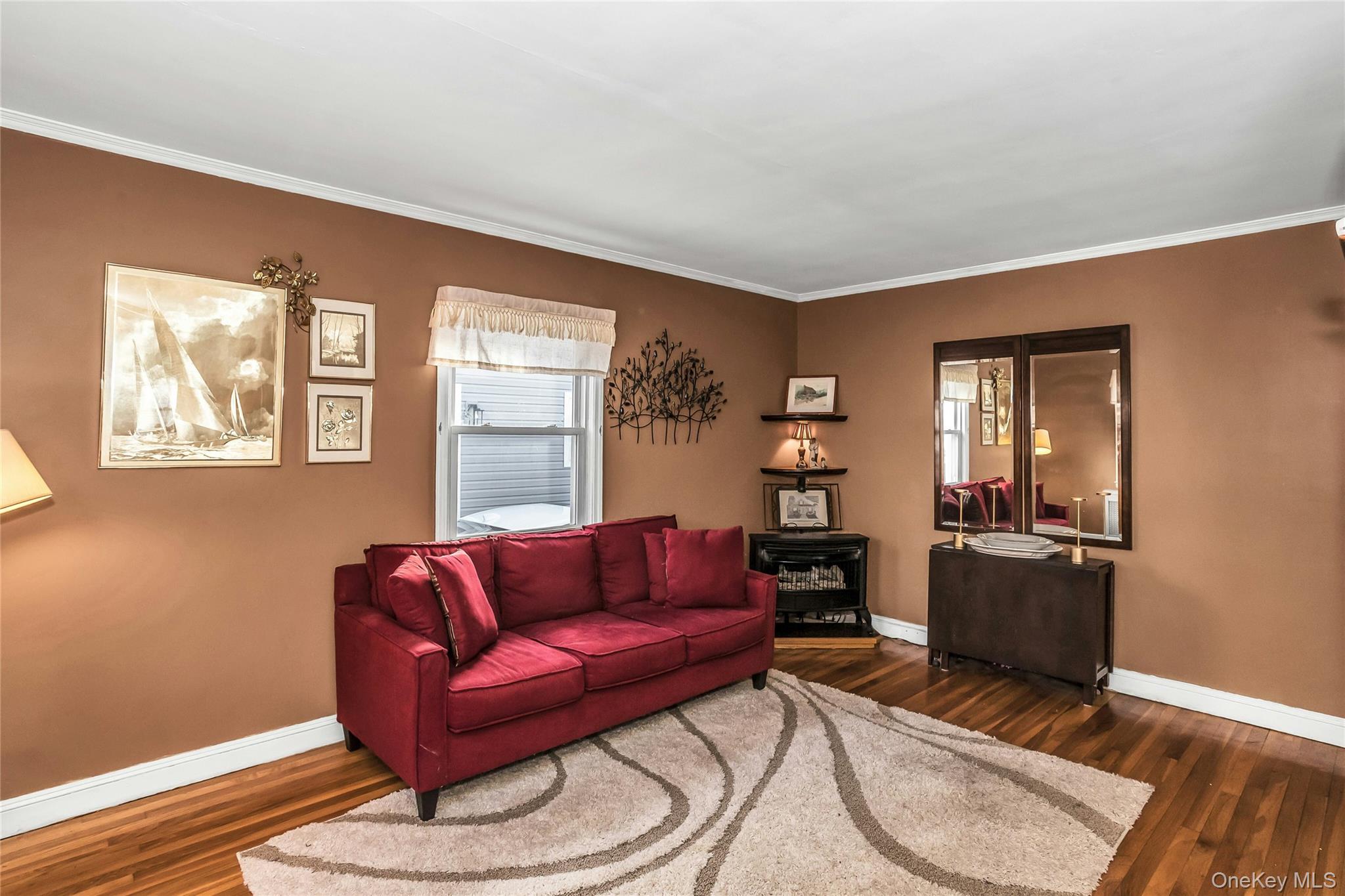 232 Ribbon Street Franklin Square, NY 11010 - Photo 4 of 19 a living room with furniture a wooden floor and a window