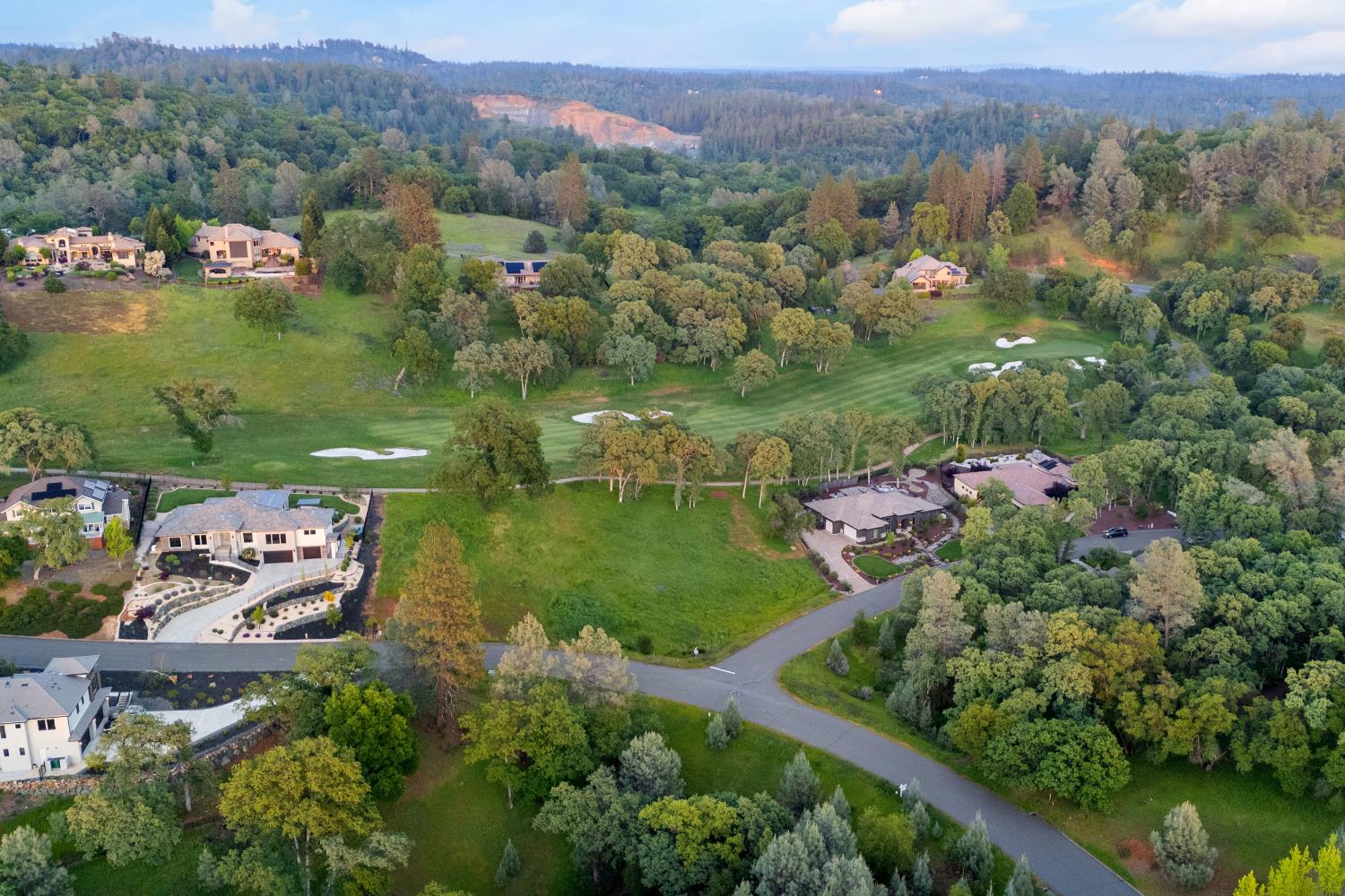 23725 Hogan Road Auburn, CA 95602 - Photo 7 of 8 an aerial view of green landscape with trees houses and mountain view