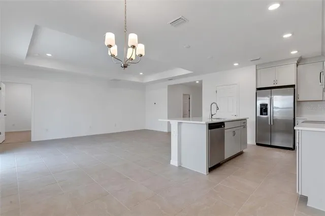 a view of a kitchen with a sink and stainless steel appliances