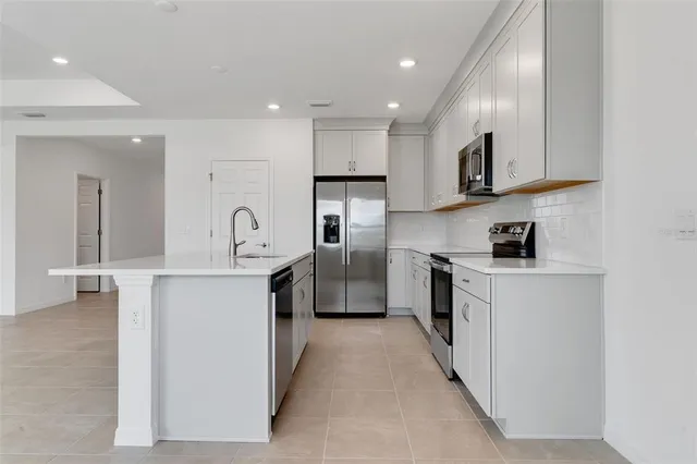 a large kitchen with stainless steel appliances lots of counter space sink and cabinets