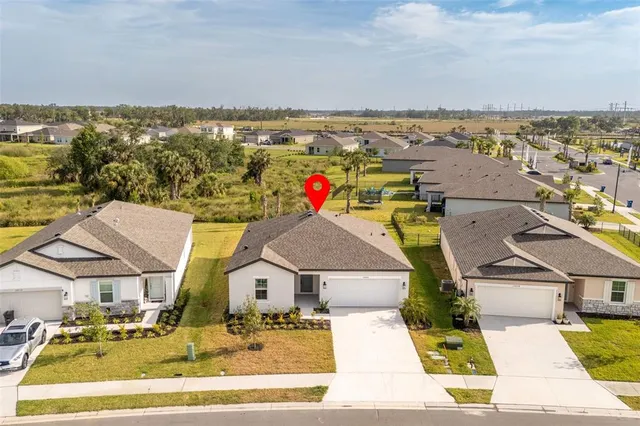 an aerial view of residential houses with outdoor space