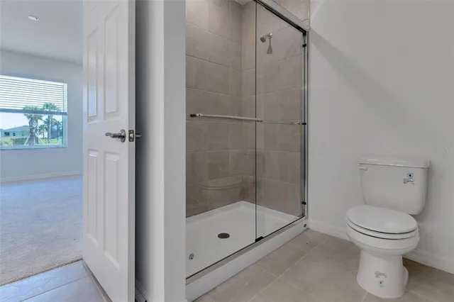 a bathroom with a shower and a toilet