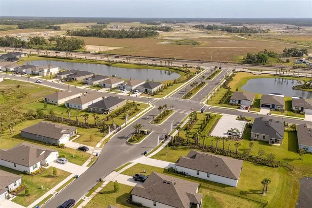 an aerial view of residential houses with outdoor space