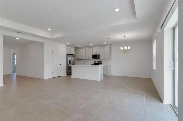 a view of a kitchen with a sink and a refrigerator