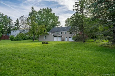 a front view of house with yard and green space