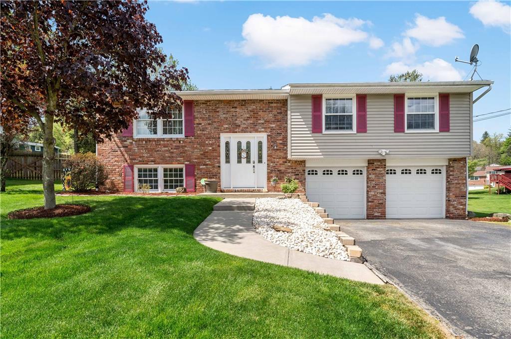 a view of a brick house with a yard