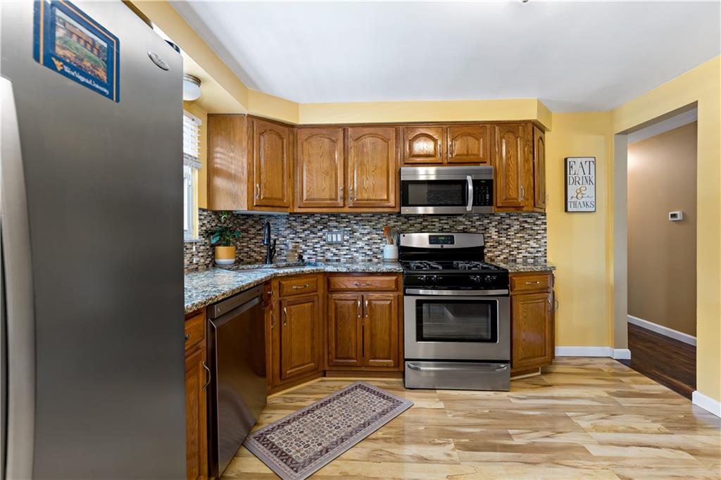 331 Trinity Drive Washington, PA 15301 - Photo 11 of 35 a kitchen with granite countertop a stove and a refrigerator