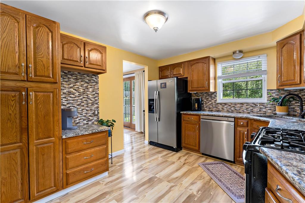 331 Trinity Drive Washington, PA 15301 - Photo 13 of 35 a kitchen with stainless steel appliances granite countertop a refrigerator stove and sink