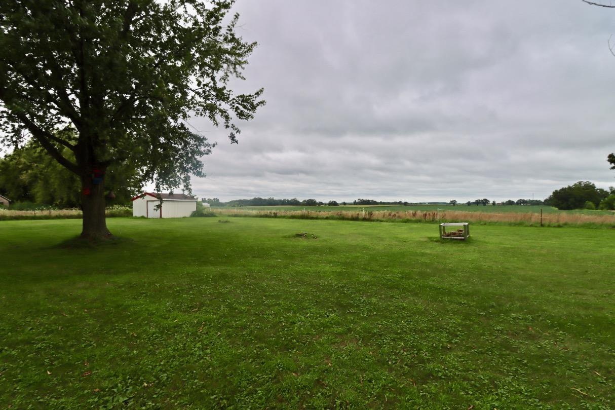 15262 Russellville Road Capron, IL 61012 - Photo 10 of 11 a backyard of a house with lots of green space