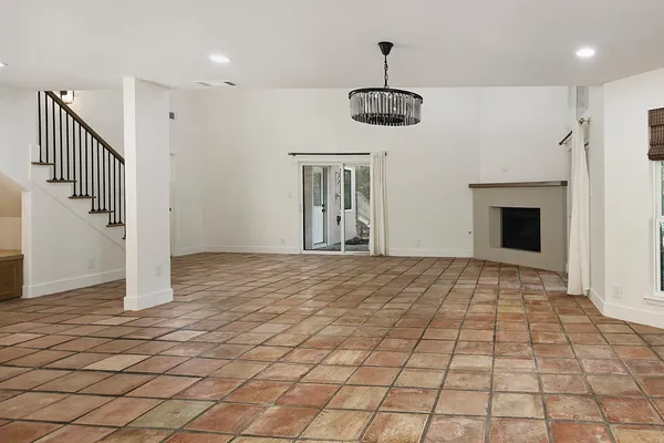 a view of an empty room with a fireplace