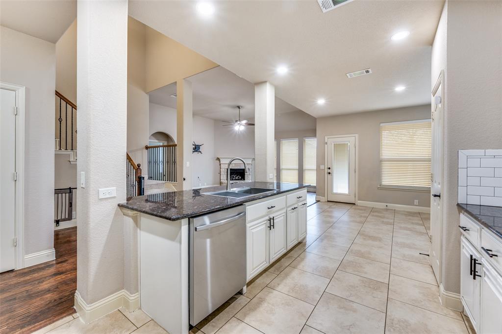 1137 Cardinal Ridge Road Burleson, TX 76028 - Photo 11 of 28 a kitchen with stainless steel appliances granite countertop a stove and a sink