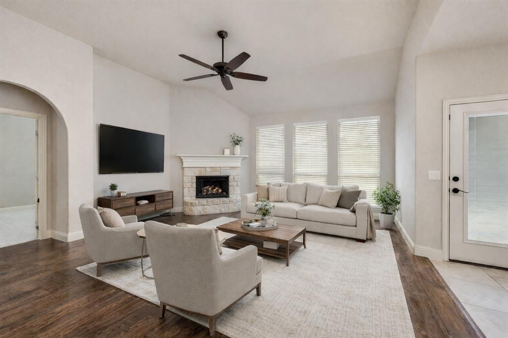 1137 Cardinal Ridge Road Burleson, TX 76028 - Photo 2 of 28 a living room with furniture a flat screen tv and a fireplace
