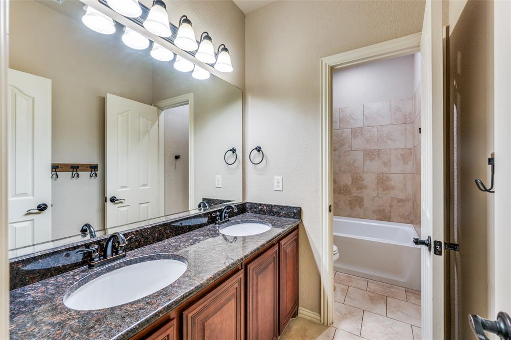1137 Cardinal Ridge Road Burleson, TX 76028 - Photo 27 of 28 a bathroom with a granite countertop sink and a mirror