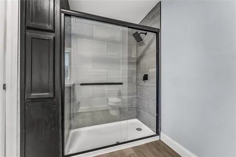 a bathroom with a glass shower door
