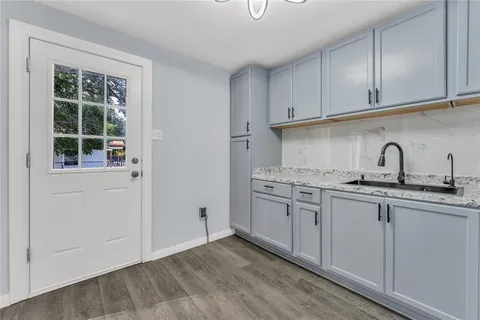 a kitchen with a sink cabinets and a window