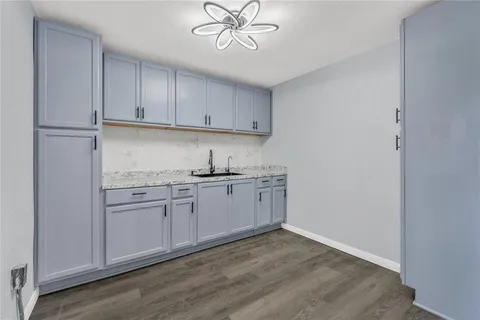 a kitchen with a sink cabinets stainless steel appliances and a window