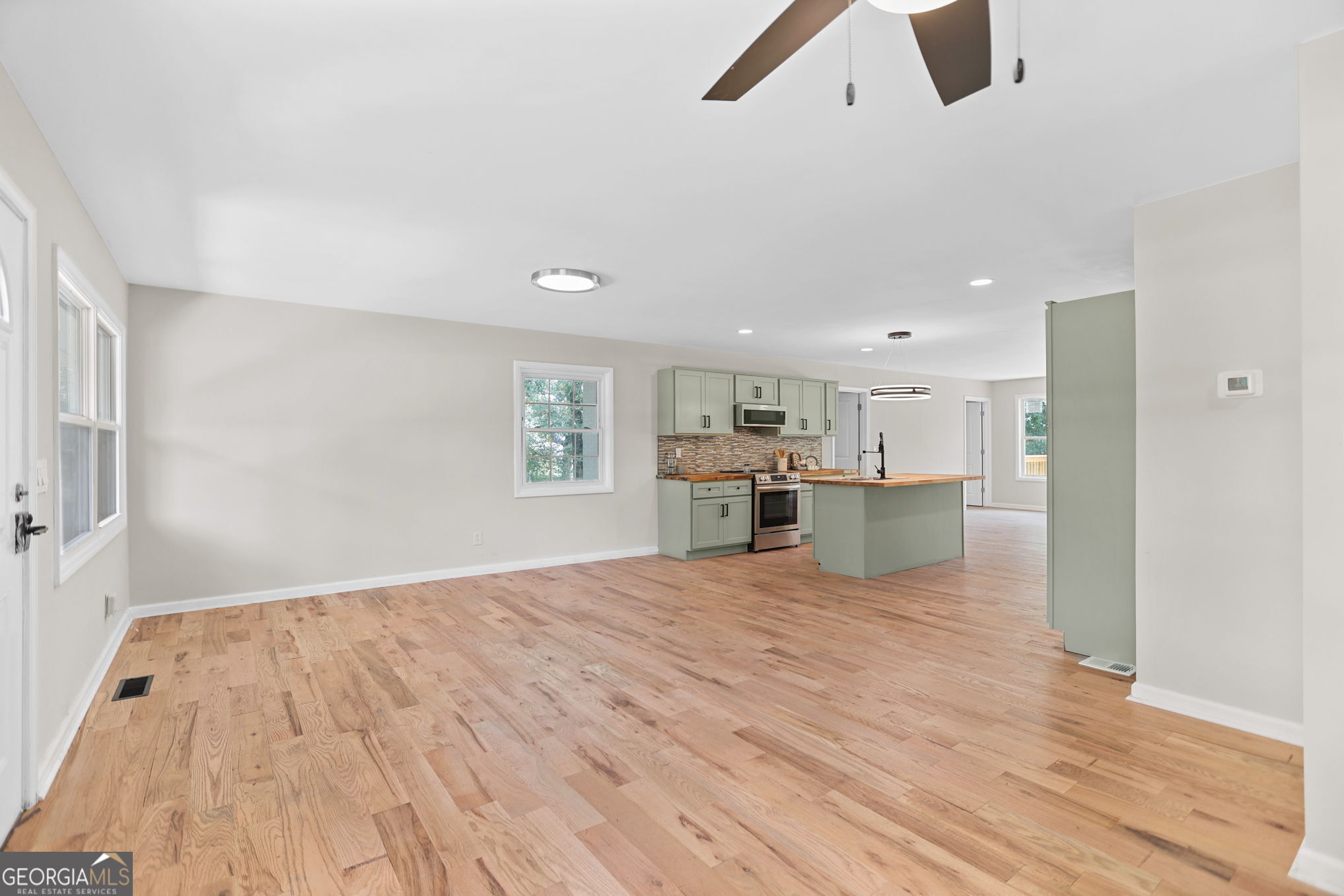 7060 Scenic Heights Road Manchester, GA 31816 - Photo 8 of 52 a view of kitchen and empty room with wooden floor