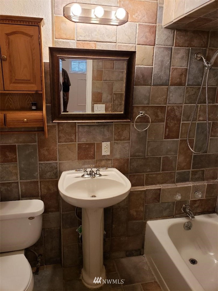 217 228th Street Southeast Bothell, WA 98021 - Photo 11 of 20 a bathroom with a sink toilet and mirror