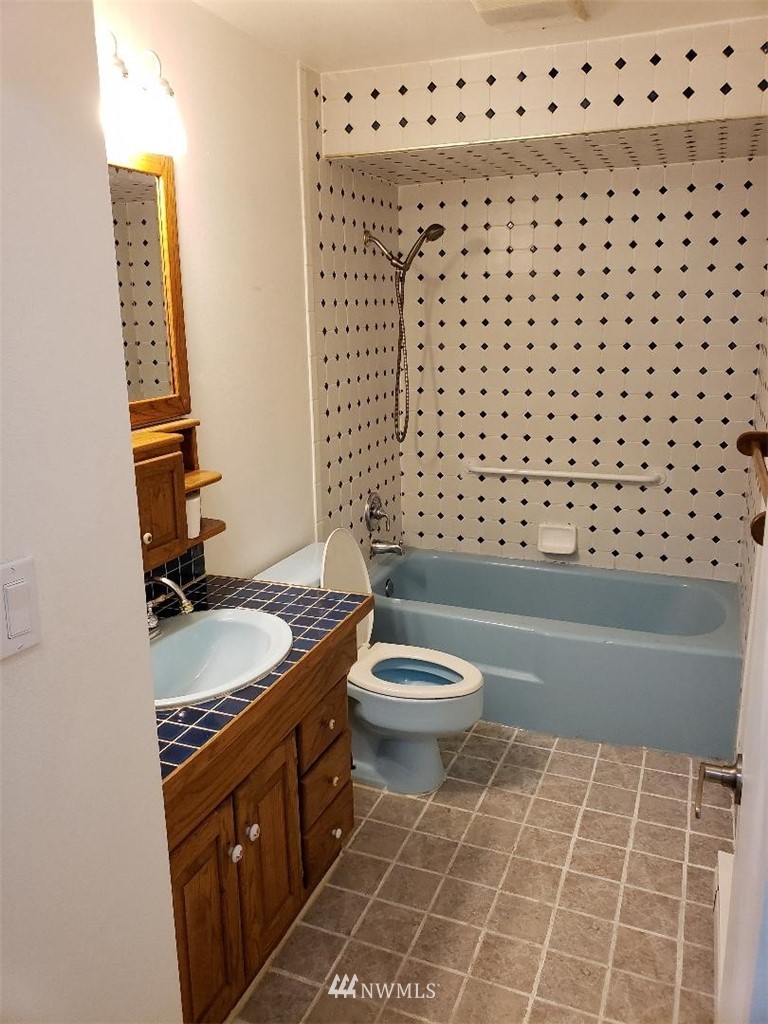 217 228th Street Southeast Bothell, WA 98021 - Photo 15 of 20 a bathroom with a granite countertop toilet and a sink