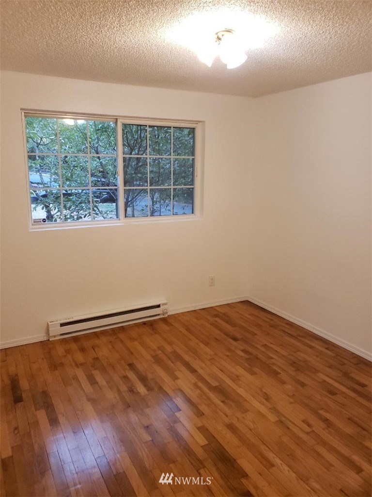 217 228th Street Southeast Bothell, WA 98021 - Photo 16 of 20 an empty room with wooden floor and windows