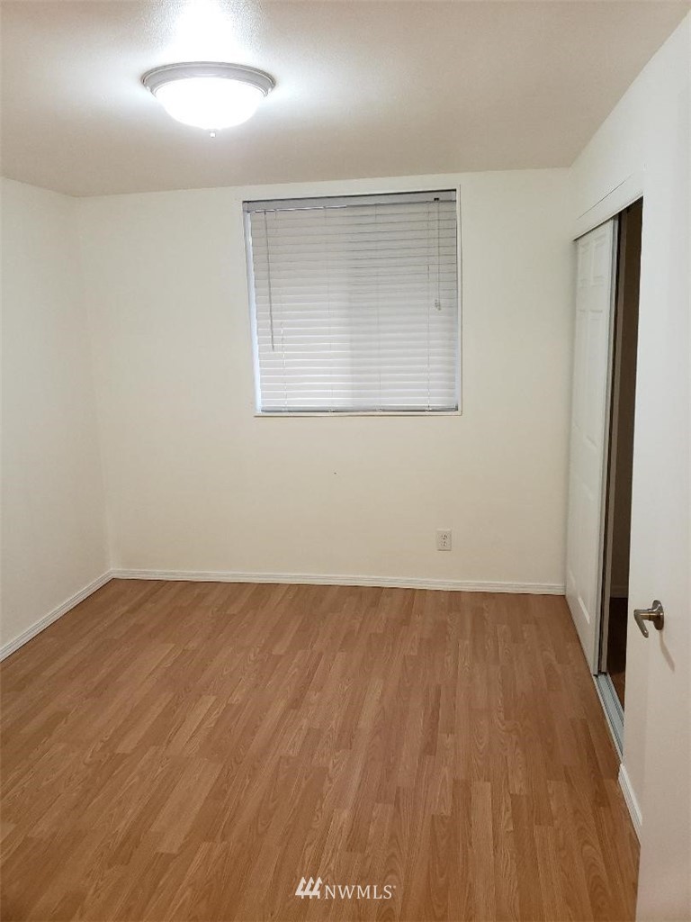 217 228th Street Southeast Bothell, WA 98021 - Photo 18 of 20 an empty room with wooden floor and windows