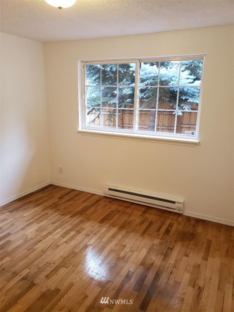 217 228th Street Southeast Bothell, WA 98021 - Photo 20 of 20 a view of an empty room with wooden floor and a window