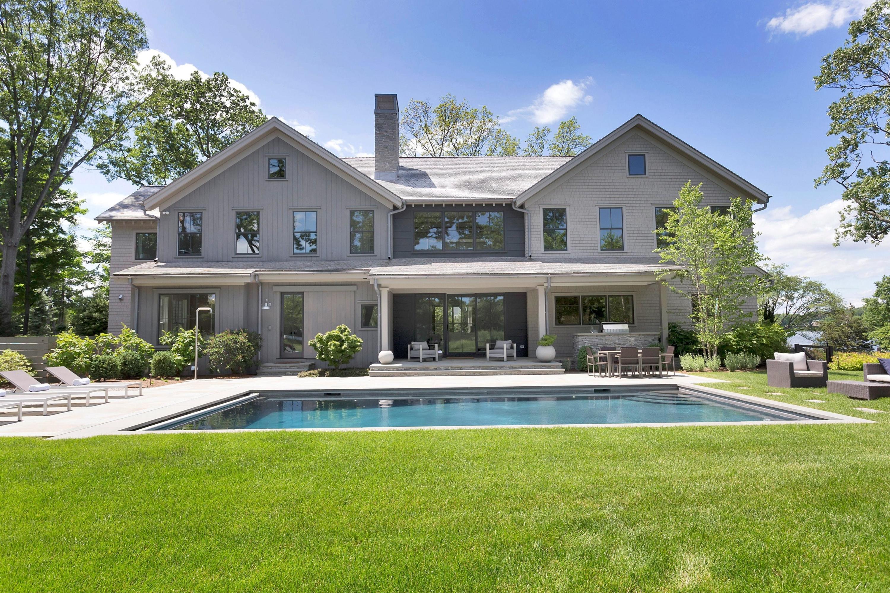 17 Brush Island Road Darien, CT 06820 - Photo 3 of 34 a front view of building with yard and outdoor seating