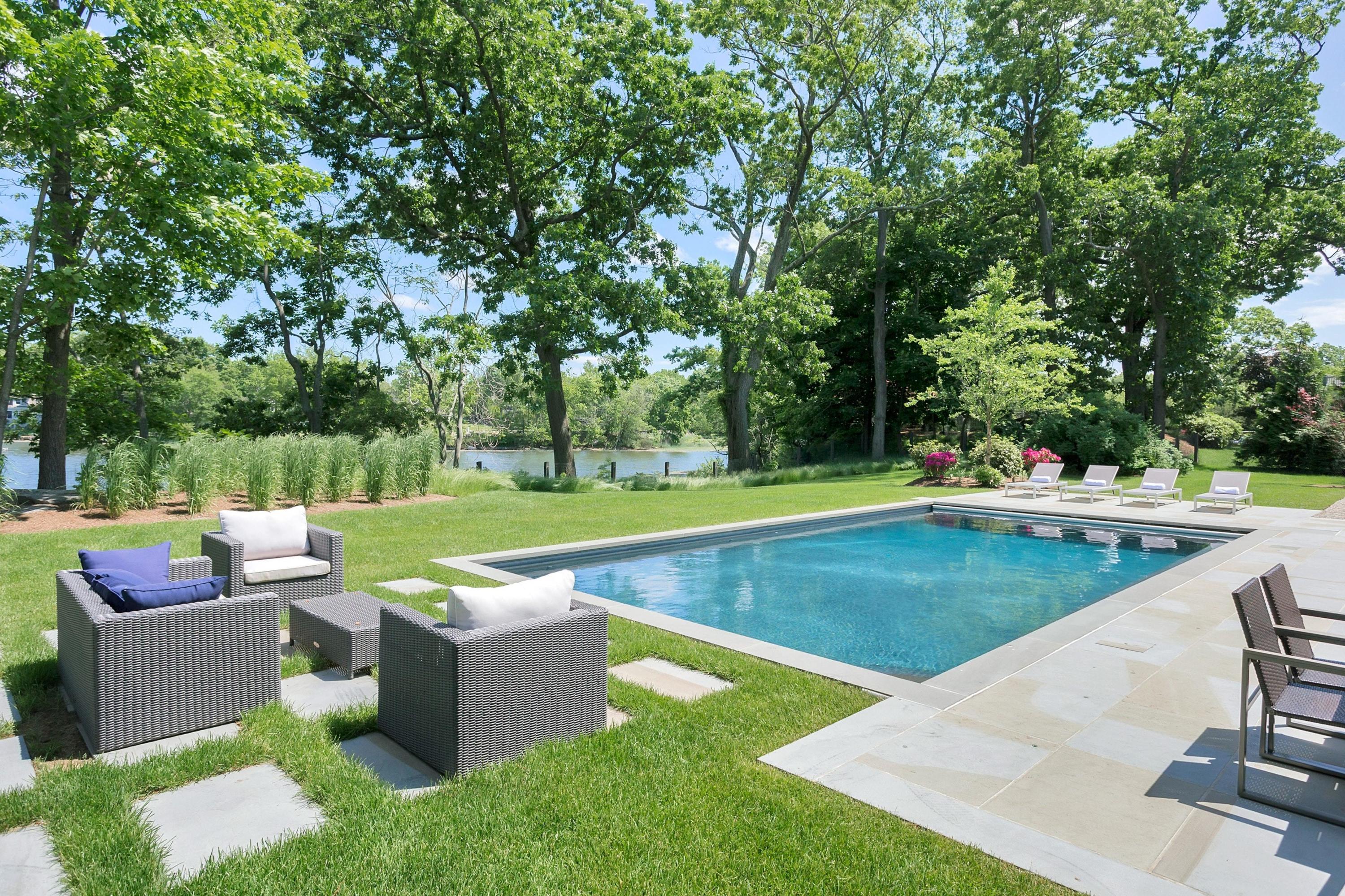 17 Brush Island Road Darien, CT 06820 - Photo 32 of 34 a view of a swimming pool with a patio
