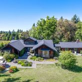 a front view of a houses with yard and green space