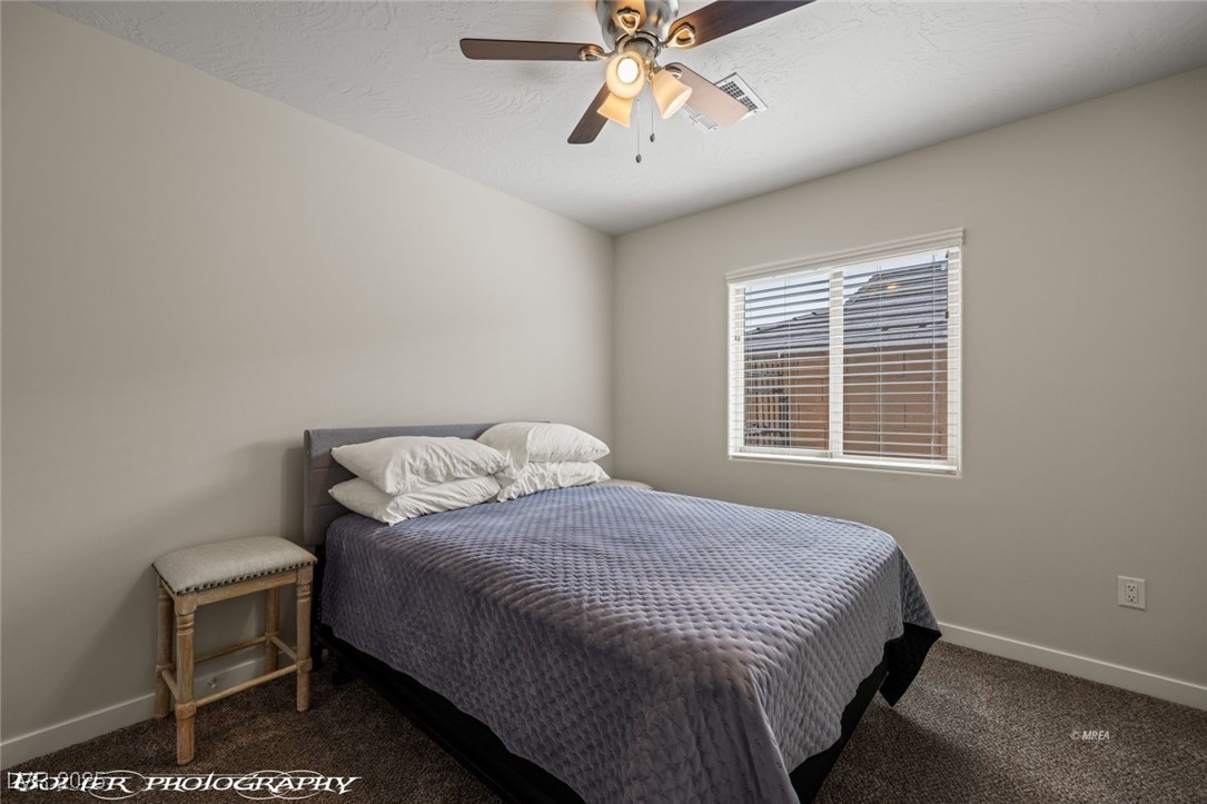 942 Shadow Hawk Ridge Mesquite, NV 89027 - Photo 35 of 67 Carpeted bedroom with baseboards and a ceiling fan