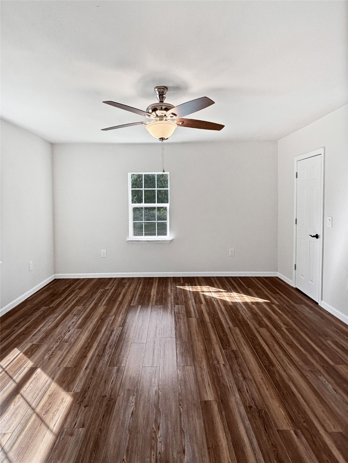 5680 Fm 252 Jasper, TX 75951 - Photo 15 of 23 wooden floor in an empty room with a window