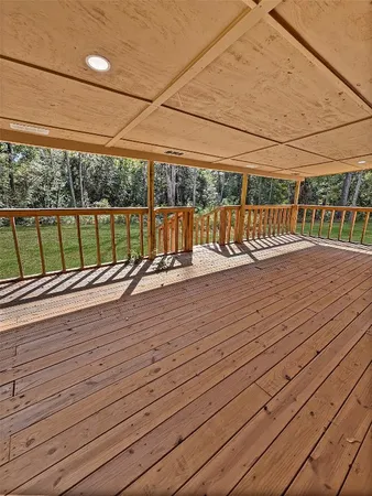 a view of a balcony with wooden floor