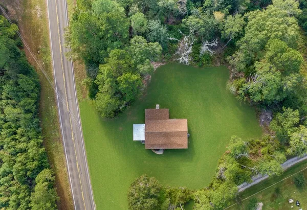 an aerial view of a house with a yard