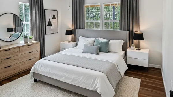 a bedroom with a large bed and a dresser