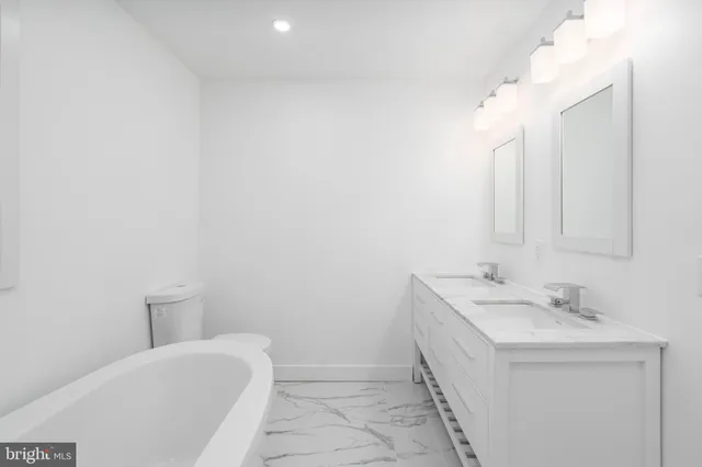 a bathroom with a sink a toilet and mirror