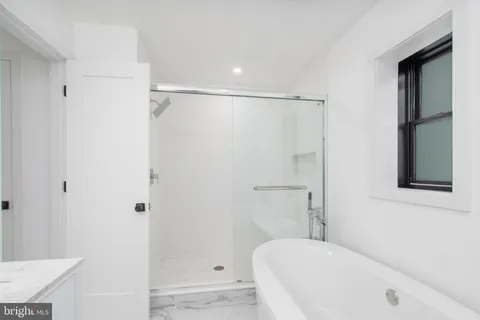 a bathroom with a bathtub and a shower