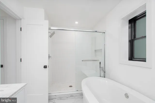 a bathroom with a bathtub and a shower
