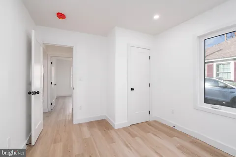 a view of a room with wooden floor and cabinet