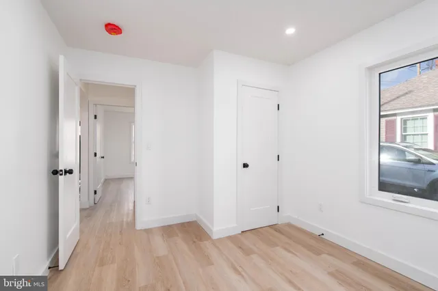 a view of a room with wooden floor and cabinet