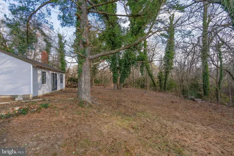 a view of a house with large trees