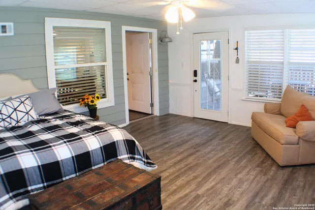 a bedroom with a bed a couch and dresser