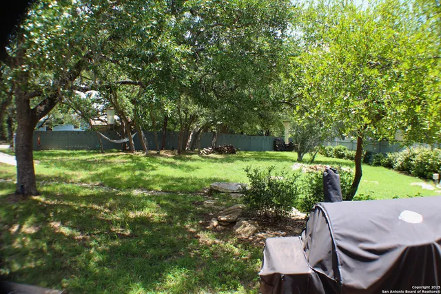 a view of yard with swimming pool and green space