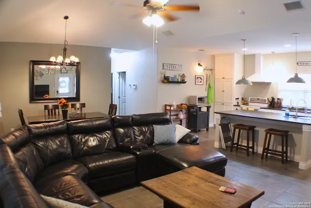 a living room with lots of furniture and kitchen view