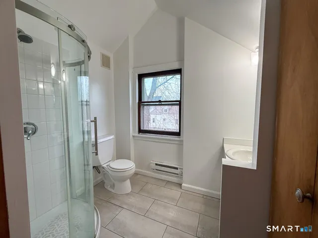 a bathroom with a toilet sink and shower