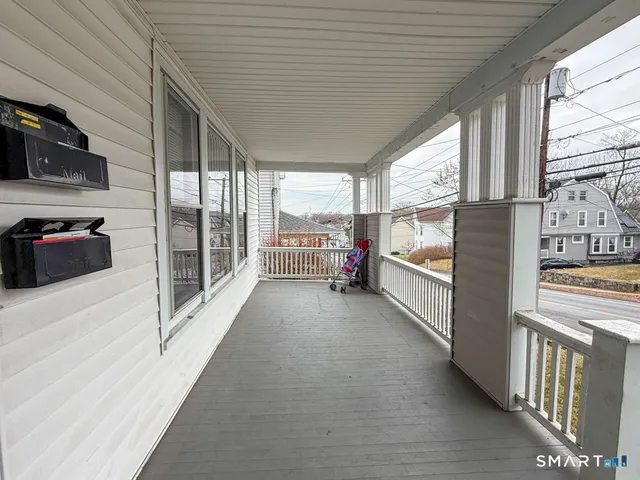 a view of living room with furniture and large windows
