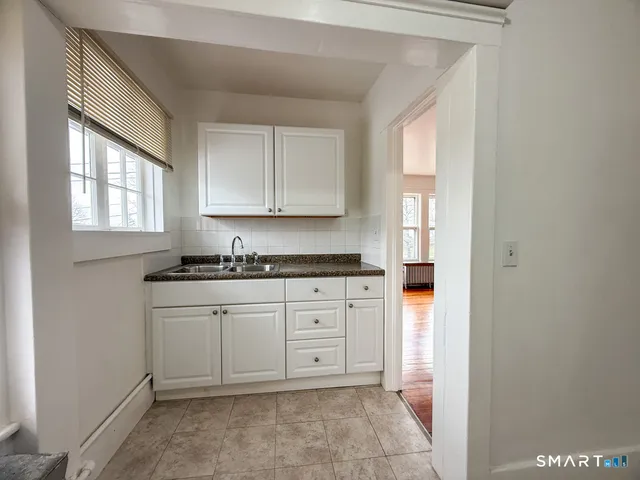 a spacious bathroom with a sink and a mirror
